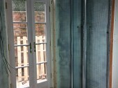 Installation of glass patio doors and cavity drainage membrane to the walls